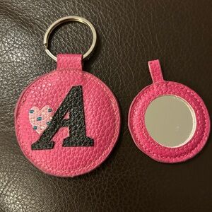 Keychain with mirror. Pink leather with purple letter A